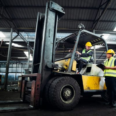 Industrious Engineer Operating Forklift in Warehouse. Efficient Forklift Driving in Factory.